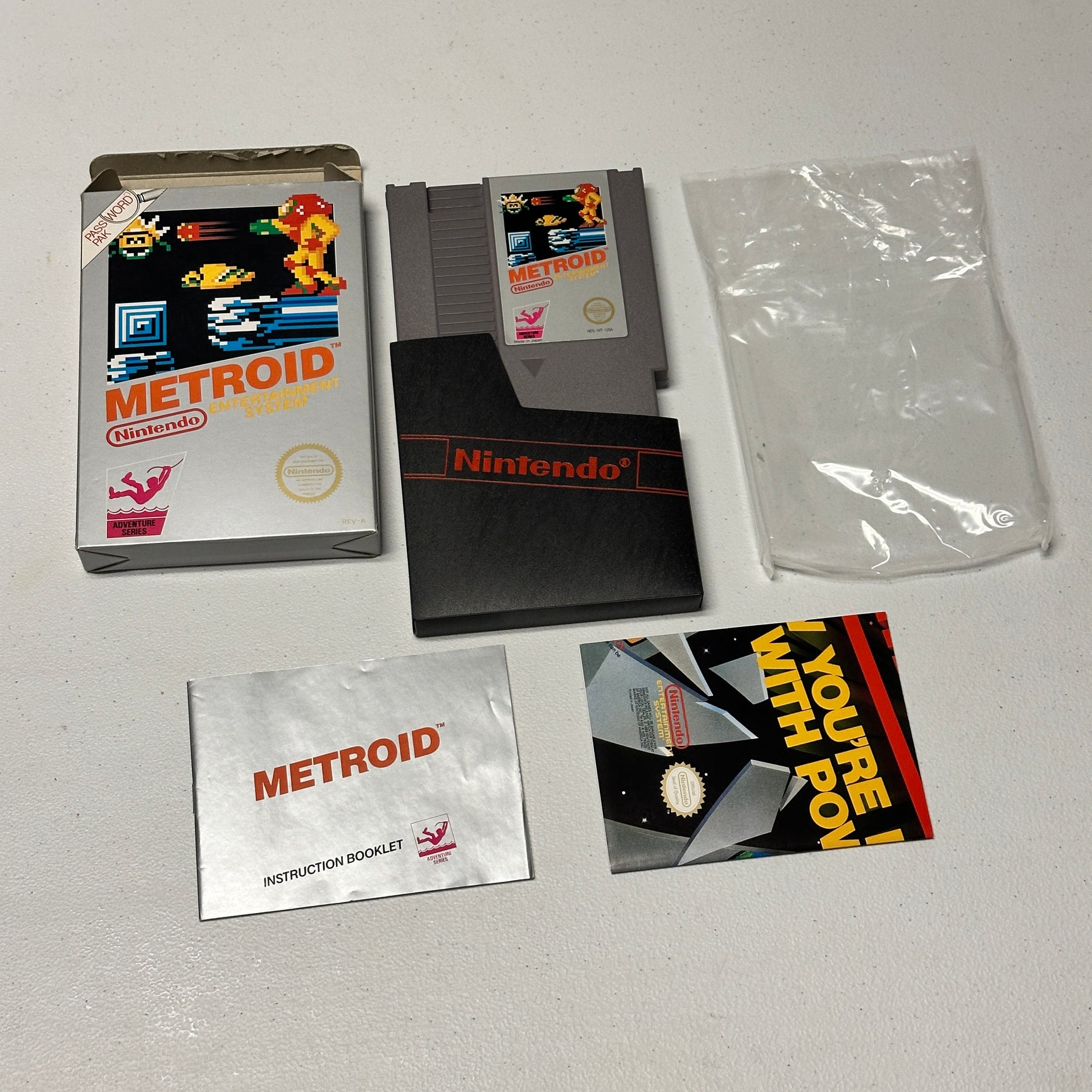 Metroid game cartridge and packaging on a gray surface
