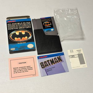 Batman video game cartridge and packaging on a gray surface